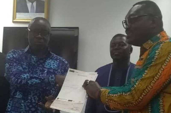 Okatakyie Amankwaa Afrifa presenting the cheque to Lands Minister Kwaku Asomah-Cheremeh